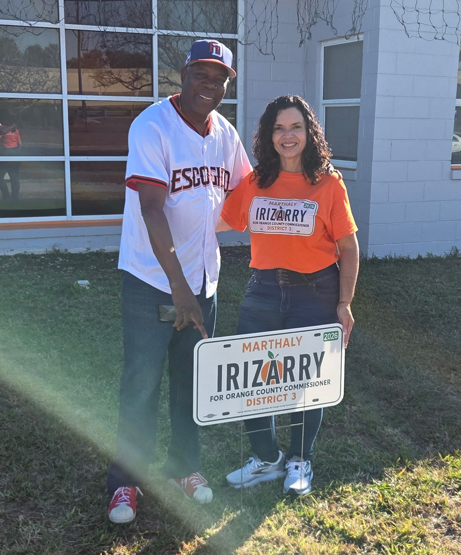 Marthaly with a community supporter holding a campaign sign